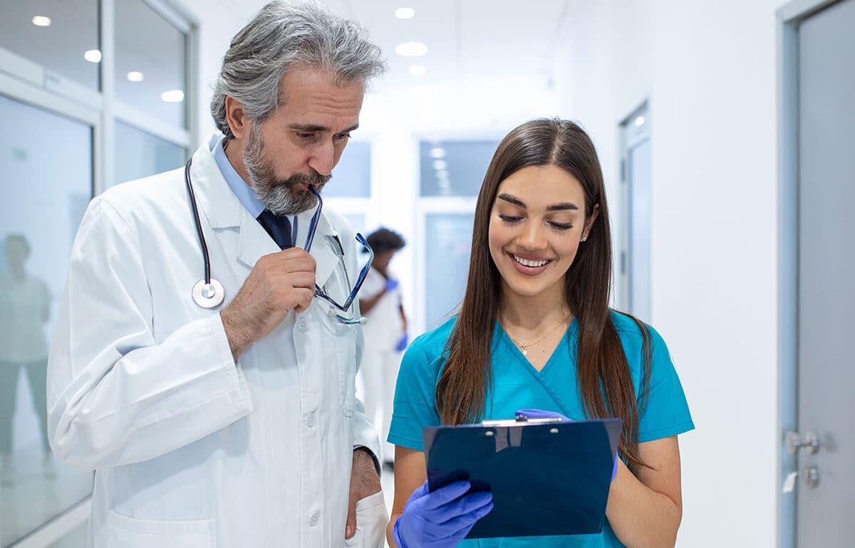 Doctors discussing patient chart.