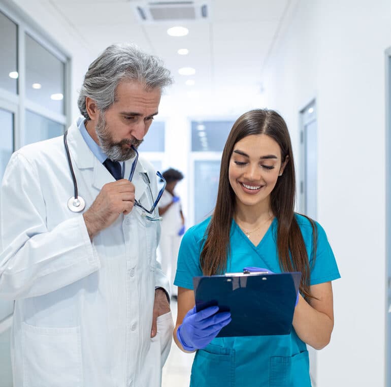 Doctors discussing patient chart.