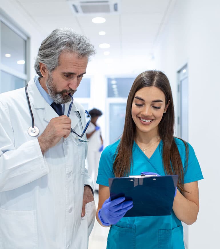 Doctors discussing patient chart.