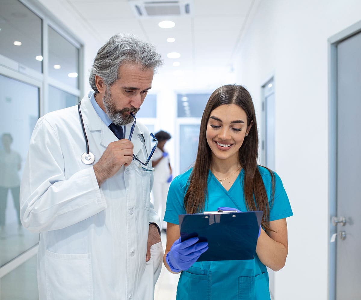 Doctors discussing patient chart.