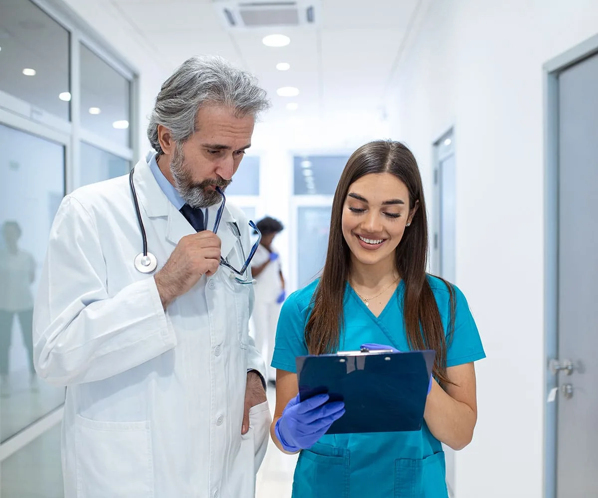 Doctors discussing patient chart.