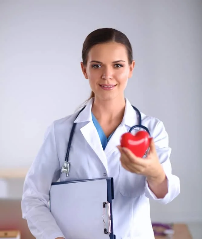 Female doctor holding heart.