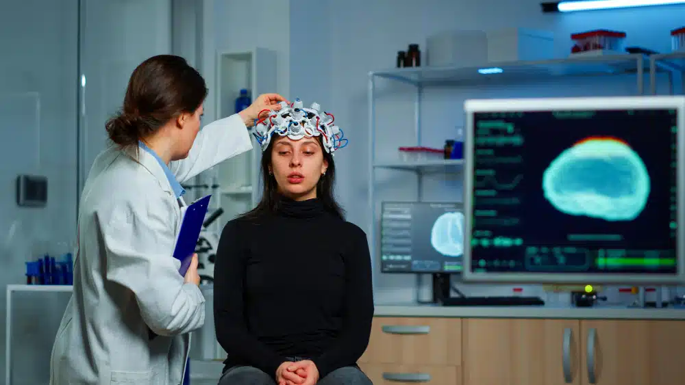 Doctor performing EEG on patient.